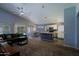Open-concept living space featuring modern ceiling fan, adjacent dining area and kitchen with an island at 287 W Liberty Ln, Gilbert, AZ 85233