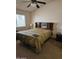 Cozy bedroom featuring a ceiling fan, window, and traditional headboard with storage at 3002 W Tonopah Dr, Phoenix, AZ 85027