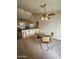 Dining area featuring a glass top table and seating, illuminated by a stylish ceiling fan at 3002 W Tonopah Dr, Phoenix, AZ 85027