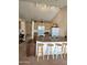 Kitchen boasting a breakfast bar with seating, white appliances, and ample lighting at 3002 W Tonopah Dr, Phoenix, AZ 85027