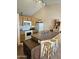 Open kitchen featuring a breakfast bar with seating, white appliances, and wood cabinets at 3002 W Tonopah Dr, Phoenix, AZ 85027
