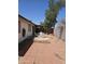 Outdoor patio area with lots of space for seating and entertaining with a privacy fence and mature trees at 3002 W Tonopah Dr, Phoenix, AZ 85027