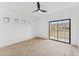 Bright bedroom features sleek ceiling fan, wood floors, and a large window with beautiful mountain views at 3434 E Baseline Rd # 265, Phoenix, AZ 85042