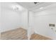 Modern bedroom with wood floors, contemporary light fixture, and adjacent closet and room at 3434 E Baseline Rd # 265, Phoenix, AZ 85042