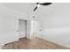 Bright, airy bedroom featuring modern ceiling fan, spacious closet, and wood flooring at 3434 E Baseline Rd # 265, Phoenix, AZ 85042