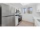 Modern kitchen features stainless steel appliances and sleek cabinets at 3434 E Baseline Rd # 265, Phoenix, AZ 85042