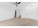 Bright living room features sleek lighting, wood floors, and multiple doorways at 3434 E Baseline Rd # 265, Phoenix, AZ 85042