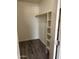 Walk-in closet with shelving, wooden rod and modern flooring at 3810 N Maryvale Pkwy # 2061, Phoenix, AZ 85031