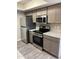 Kitchen features stainless steel appliances, granite countertops and gray cabinets at 3810 N Maryvale Pkwy # 2061, Phoenix, AZ 85031