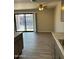 Open living room with new floors, fan, and sliding glass doors leading to the patio at 3810 N Maryvale Pkwy # 2061, Phoenix, AZ 85031