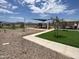 Community playground featuring slides, shade structures, picnic tables and lush green spaces at 3916 S 98Th Ln, Tolleson, AZ 85353