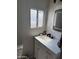 Bathroom vanity with marble countertop, black faucet, and modern mirror at 4065 E University Dr # 242, Mesa, AZ 85205