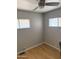 Bedroom with two windows, ceiling fan, hardwood floors, and neutral painted walls at 4065 E University Dr # 242, Mesa, AZ 85205