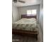 Bedroom with wooden bed, drawers underneath, and window with natural light at 4065 E University Dr # 242, Mesa, AZ 85205