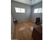 Bedroom with hardwood floors, desk, and two windows at 4065 E University Dr # 242, Mesa, AZ 85205
