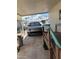 Carport with EV parked beneath the ceiling and palm trees in view in background at 4065 E University Dr # 242, Mesa, AZ 85205
