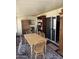 Dining room with wooden table and chairs, sliding glass door, and dark wood shelving at 4065 E University Dr # 242, Mesa, AZ 85205