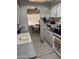 Practical kitchen design with bright lighting, stove, sink, and functional appliances; dining area in the background at 4065 E University Dr # 242, Mesa, AZ 85205