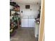 Laundry room with washer and dryer along with metal shelving on back wall for storage at 4065 E University Dr # 242, Mesa, AZ 85205