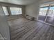 Bright living room featuring laminate flooring and sliding glass door at 4065 E University Dr # 242, Mesa, AZ 85205