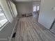 Sunlit living room featuring laminate flooring and neutral-toned walls at 4065 E University Dr # 242, Mesa, AZ 85205