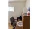 Office area with desk, chair, window, and neutral painted walls at 4065 E University Dr # 242, Mesa, AZ 85205