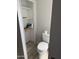 Compact powder room with toilet, storage shelves, and modern fixtures, providing essential convenience at 4065 E University Dr # 242, Mesa, AZ 85205