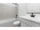 Clean, bright bathroom featuring a tub with marble surround and modern fixtures at 42460 W Peters Dr, Maricopa, AZ 85138