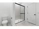 Contemporary bathroom showcasing a sleek glass shower and toilet area at 42460 W Peters Dr, Maricopa, AZ 85138