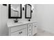 Modern bathroom featuring a double sink vanity with elegant black fixtures at 42460 W Peters Dr, Maricopa, AZ 85138