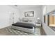 Stylishly staged bedroom with ample light, contemporary decor, and neutral colors at 42460 W Peters Dr, Maricopa, AZ 85138