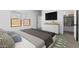 Inviting bedroom with a mounted TV, stylish dresser, and comfortable bedding at 42460 W Peters Dr, Maricopa, AZ 85138