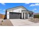 Charming single-story home with a gray door, a gray garage door, and blue shutters at 42460 W Peters Dr, Maricopa, AZ 85138