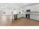 Bright kitchen features stainless steel appliances, white cabinets, an island, and hardwood floors at 42460 W Peters Dr, Maricopa, AZ 85138