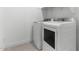 Well-equipped laundry room featuring modern washer and dryer units at 42460 W Peters Dr, Maricopa, AZ 85138