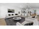 Stylish living room featuring hardwood floors, neutral colors, and an open-concept design at 42460 W Peters Dr, Maricopa, AZ 85138