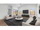 Bright living room featuring modern furnishings, recessed lighting, and wood flooring at 42460 W Peters Dr, Maricopa, AZ 85138