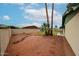 Low-maintenance backyard with desert landscaping, mature palm trees, and a stone path to the patio at 4530 W Larkspur Dr, Glendale, AZ 85304