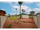 Desert landscaping enhances this backyard, with a gravel bed and mature palm trees providing shade at 4530 W Larkspur Dr, Glendale, AZ 85304