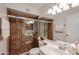 Bathroom featuring a large shower with glass doors, stylish vanity, and a toilet at 4530 W Larkspur Dr, Glendale, AZ 85304