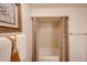 Bathroom featuring shower with decorative curtain, towel, and framed art at 4530 W Larkspur Dr, Glendale, AZ 85304