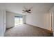 Bright bedroom showcasing a sliding glass door leading to the backyard and neutral carpeting at 4530 W Larkspur Dr, Glendale, AZ 85304