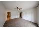 Spacious bedroom featuring a ceiling fan, plush carpet, and an en suite bathroom at 4530 W Larkspur Dr, Glendale, AZ 85304