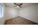 Bedroom featuring neutral paint, plush carpeting, a ceiling fan and closet at 4530 W Larkspur Dr, Glendale, AZ 85304