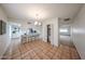 Open dining area with tile floors, bar seating, storage, and seamless flow at 4530 W Larkspur Dr, Glendale, AZ 85304