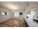 Dining area with tile flooring, breakfast bar, and modern lighting at 4530 W Larkspur Dr, Glendale, AZ 85304