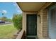 Close up of front door featuring brick accents, with a view of manicured lawn at 4530 W Larkspur Dr, Glendale, AZ 85304