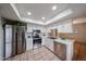 Bright kitchen with stainless steel appliances and white cabinetry, creating a modern and airy space at 4530 W Larkspur Dr, Glendale, AZ 85304