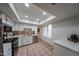 Bright kitchen with stainless steel appliances, white cabinetry, and a skylight, creating a modern and airy space at 4530 W Larkspur Dr, Glendale, AZ 85304