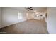 Inviting living room featuring carpet, ceiling fan, and ample natural light at 4530 W Larkspur Dr, Glendale, AZ 85304